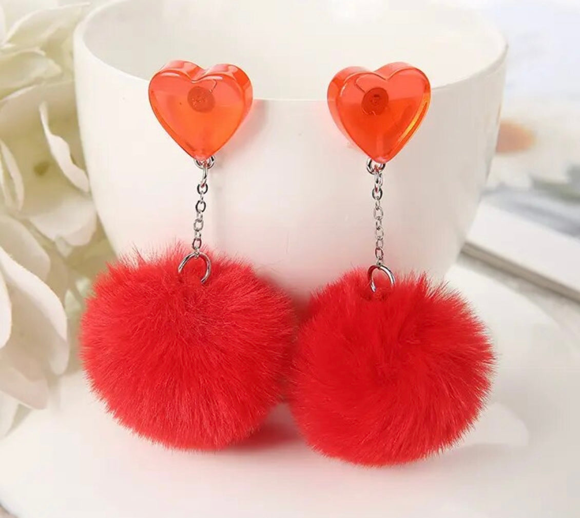 PREORDER VALENTINES DAY ROUND ONE Red Heart Pom Pom Earrings. Estimated Arrival January 15.